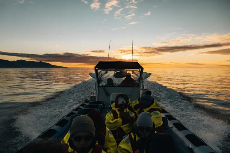 group of people on a boat at sunset in Iceland