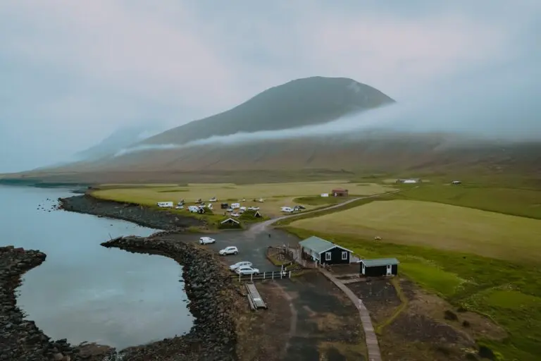 drone shot of a coastal campsite in Iceland with misty mountains