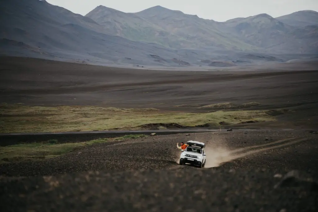 white 4x4 driving on a dirt road in Iceland's highlands